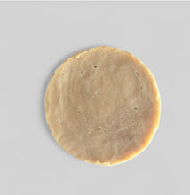an unpackaged shaving puck