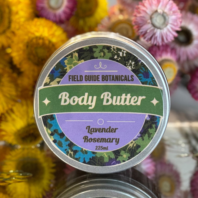 a 225 ml tub of lavender and rosemary body butter in front of dried straw flowers